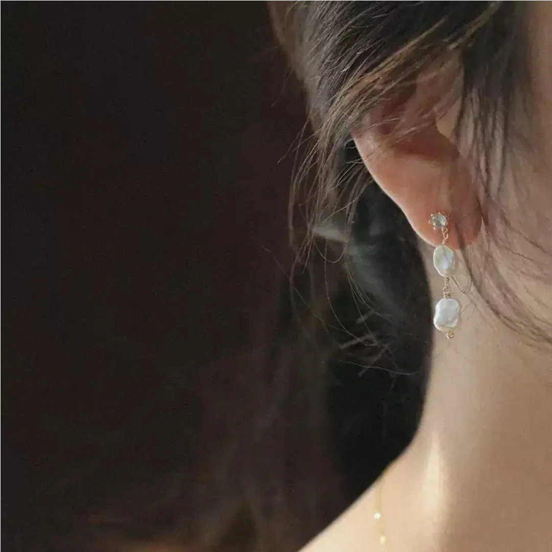Elegant asymmetric baroque freshwater pearl earrings worn by model to highlight jawline and romantic atmosphere - model-look-1