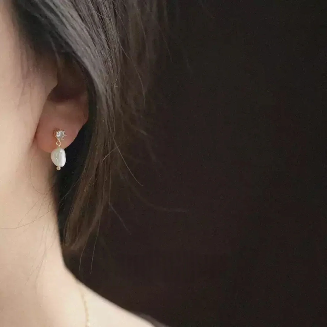 Elegant asymmetric baroque freshwater pearl earrings worn by model to highlight jawline and romantic atmosphere - model-look-2