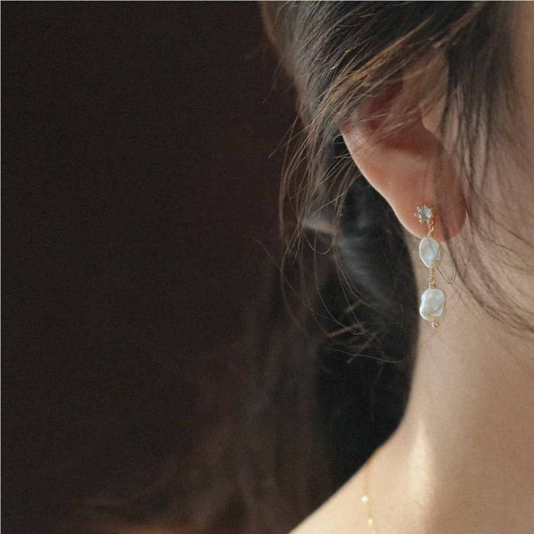 Elegant asymmetric baroque freshwater pearl earrings worn by model to highlight jawline and romantic atmosphere - model-look-3