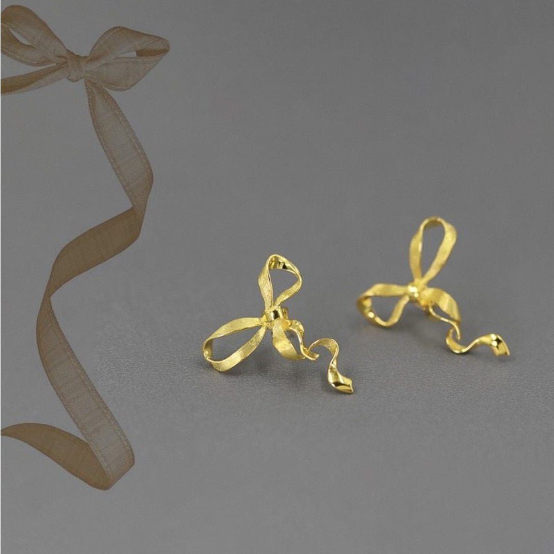 Sculptural Ribbon Bow earrings in S925 gold plated silver showing 3D fluid design - product-studio-1