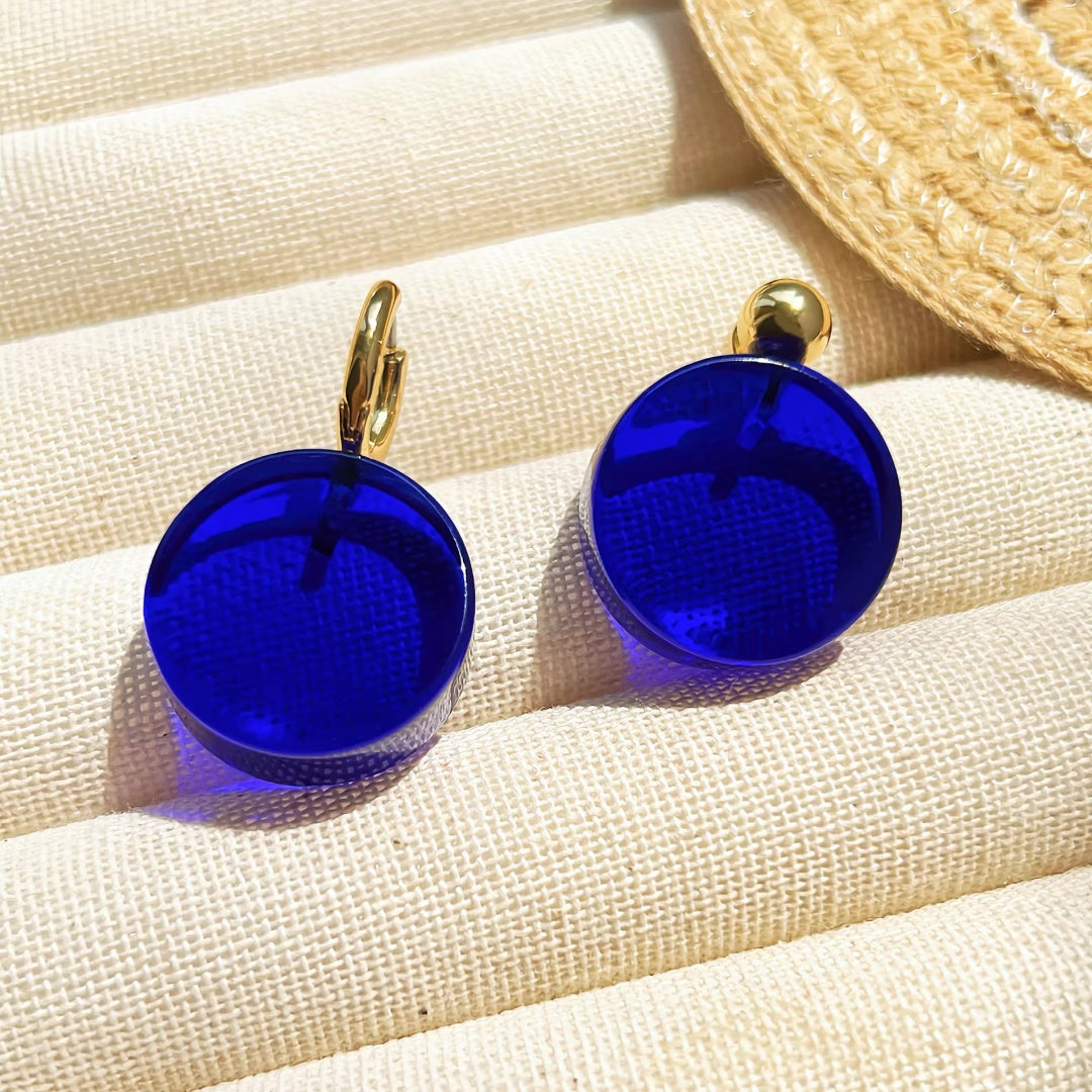 Deep Klein Blue glass earrings in hoop and stud styles with 18K gold plating.
