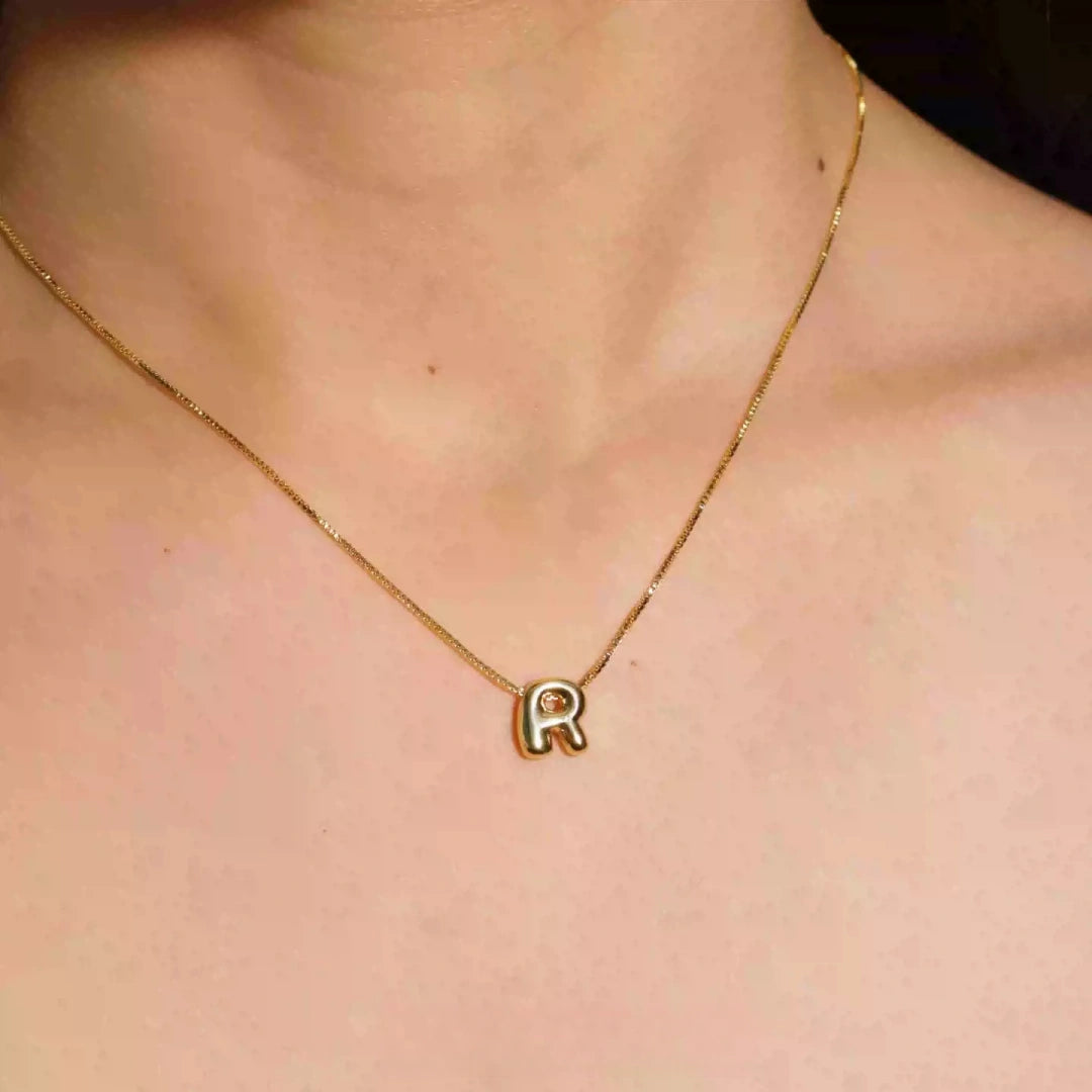 Dainty 18K gold plated 3D bubble initial R necklace on model's neck, minimalist aesthetic.