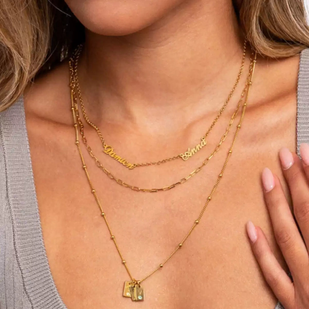 Elegant woman wearing an asymmetric  2 name necklace in sterling silver, a perfect personalised gift for mothers.