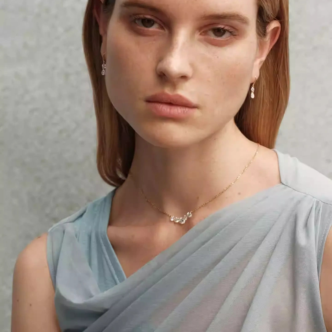 Bride wearing moissanite wedding jewelry set with smile necklace and shimmering pear drop earrings for an elegant bridal look. Model Images 2