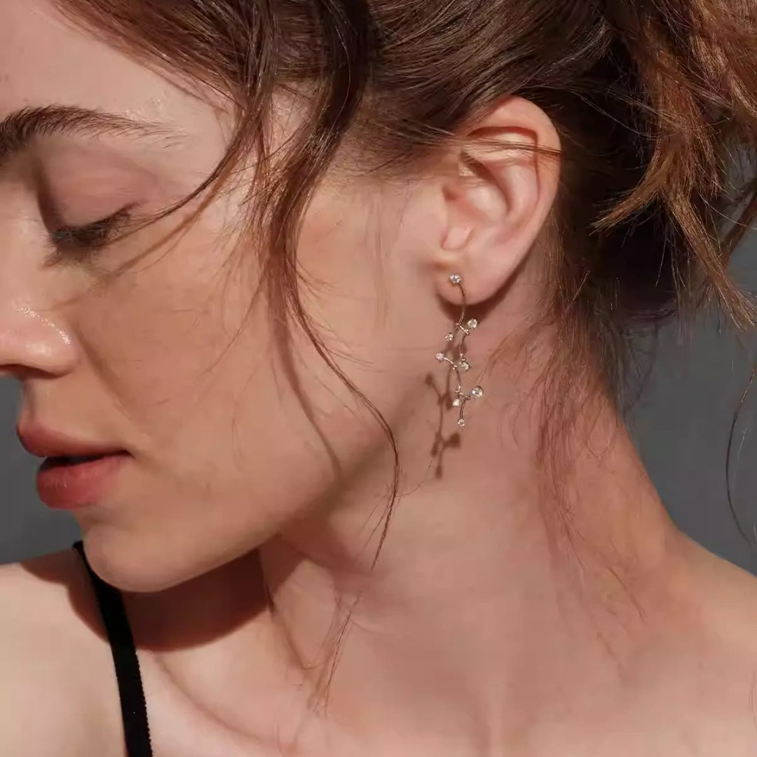 Elegant nature-inspired vine drop earrings in S925 silver featuring a swaying design to slim the face, ideal for brides. 3