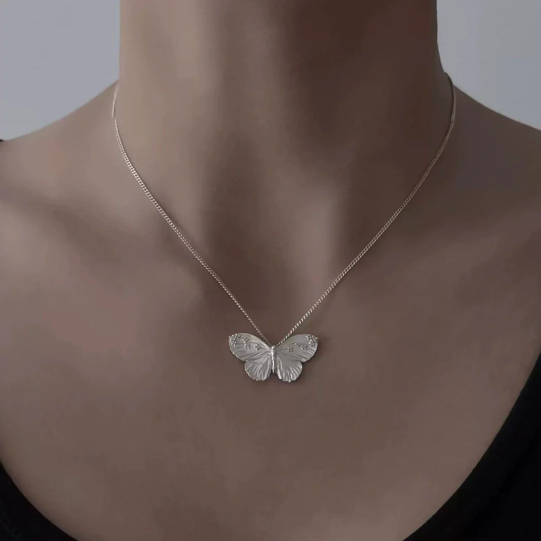 Textured Wing butterfly necklace in S925 sterling silver worn by a model to show the elegant collarbone fit - model-look-1